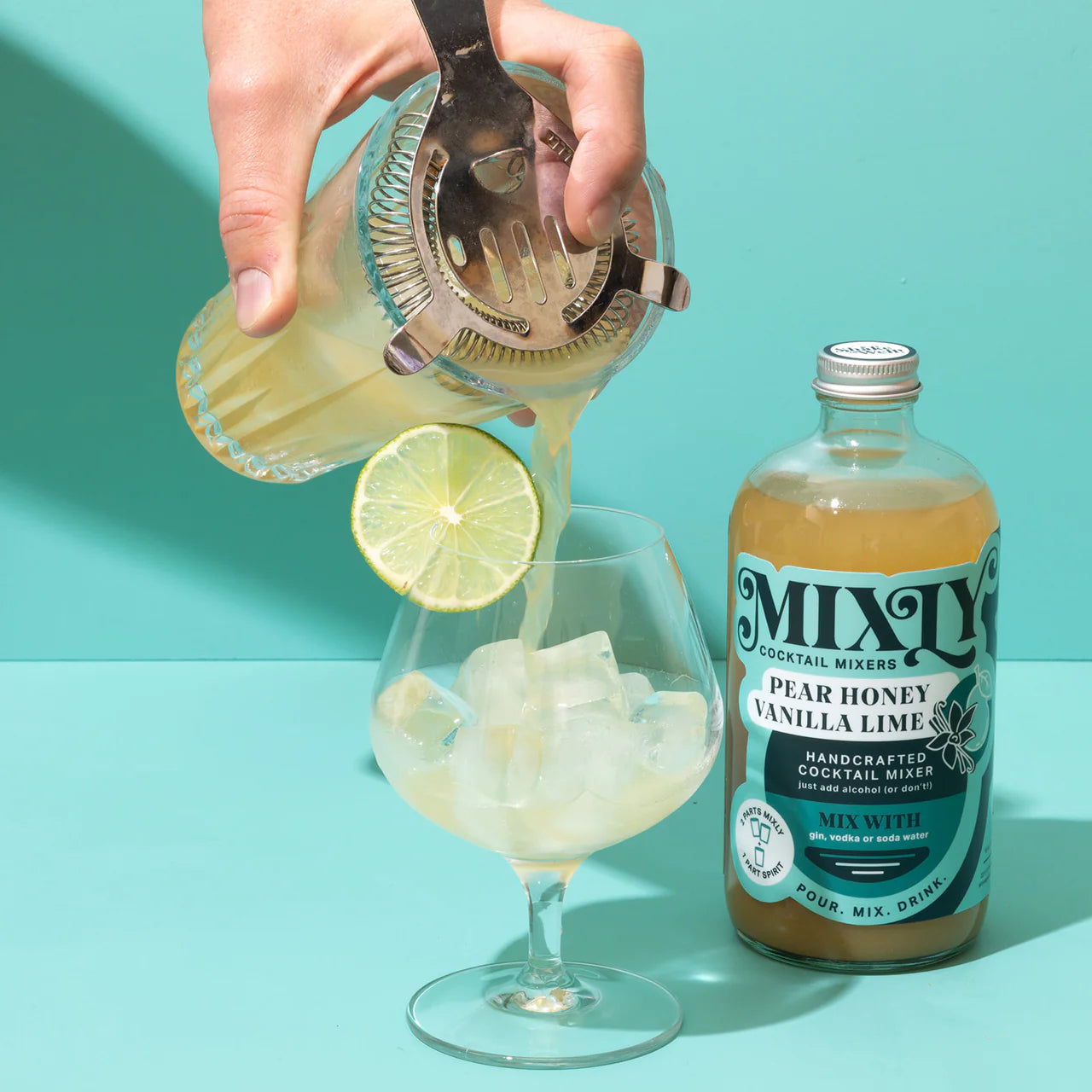 Mixly pear vanilla being poured into a glass next to the bottle