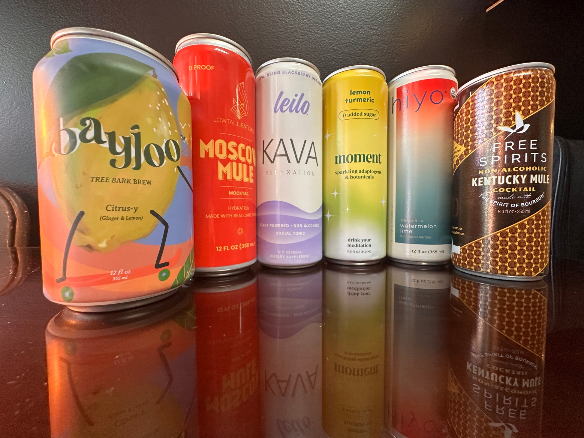 6 drinks displayed next to eachother. The cans on the ends are smaller than the others. 