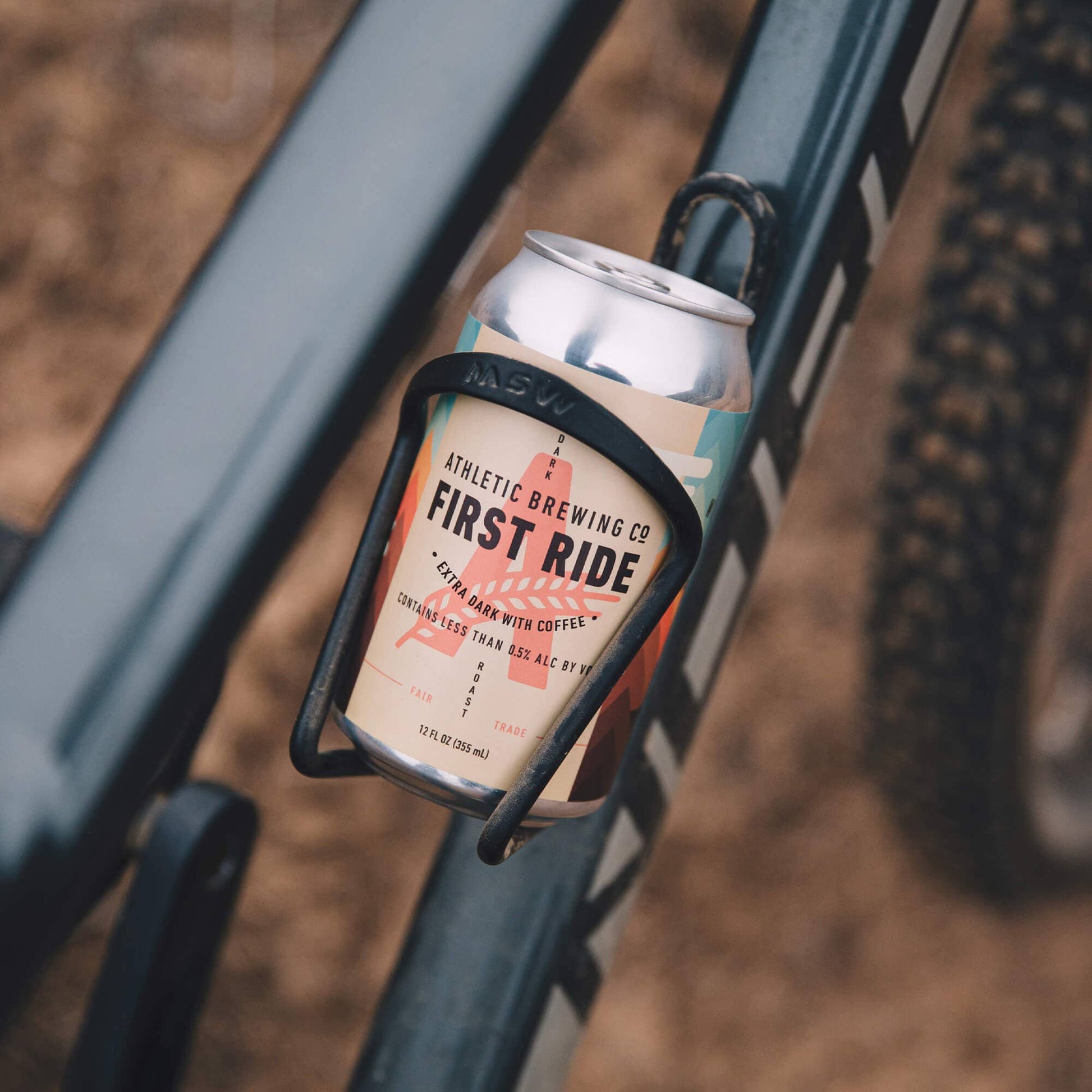 a can of first ride placed inside a water bottle holder on a bike