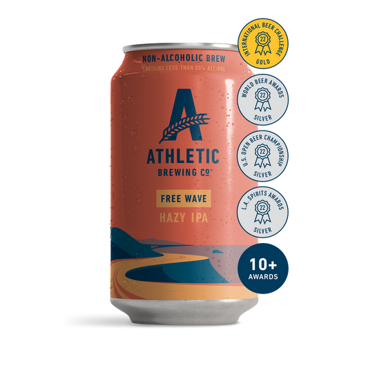 athletic brewing co's free wave, hazy IPA. The can has a simplistic illustration of a seaside road heacing towards the horizon drawin in reds and blues