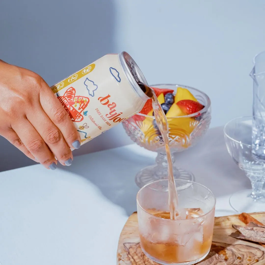a can of bliss being poured into a glass with ice