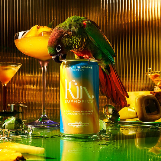 a kin euphoric's get your glow, actual sunshine can beng pecked at by a parakeet next to a margarita