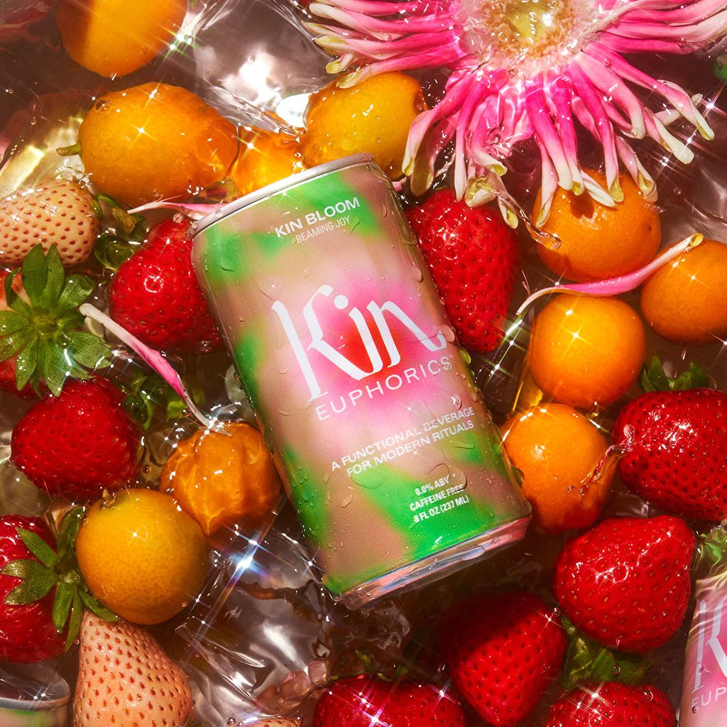 a can of kin bloom with a vareity of fruits and a flower