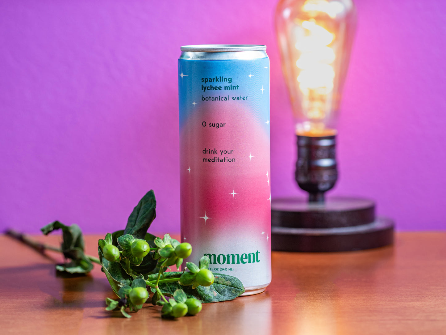 a can of moment's sparkling lychee mint botanical water