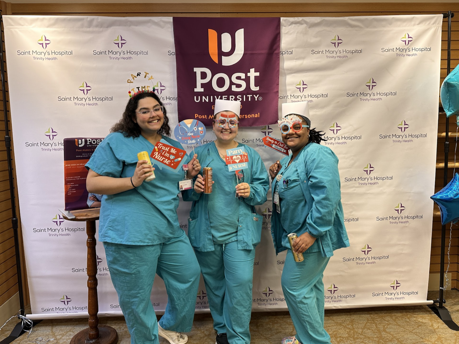 a picture of three nurses from post university posing for a celebration photo