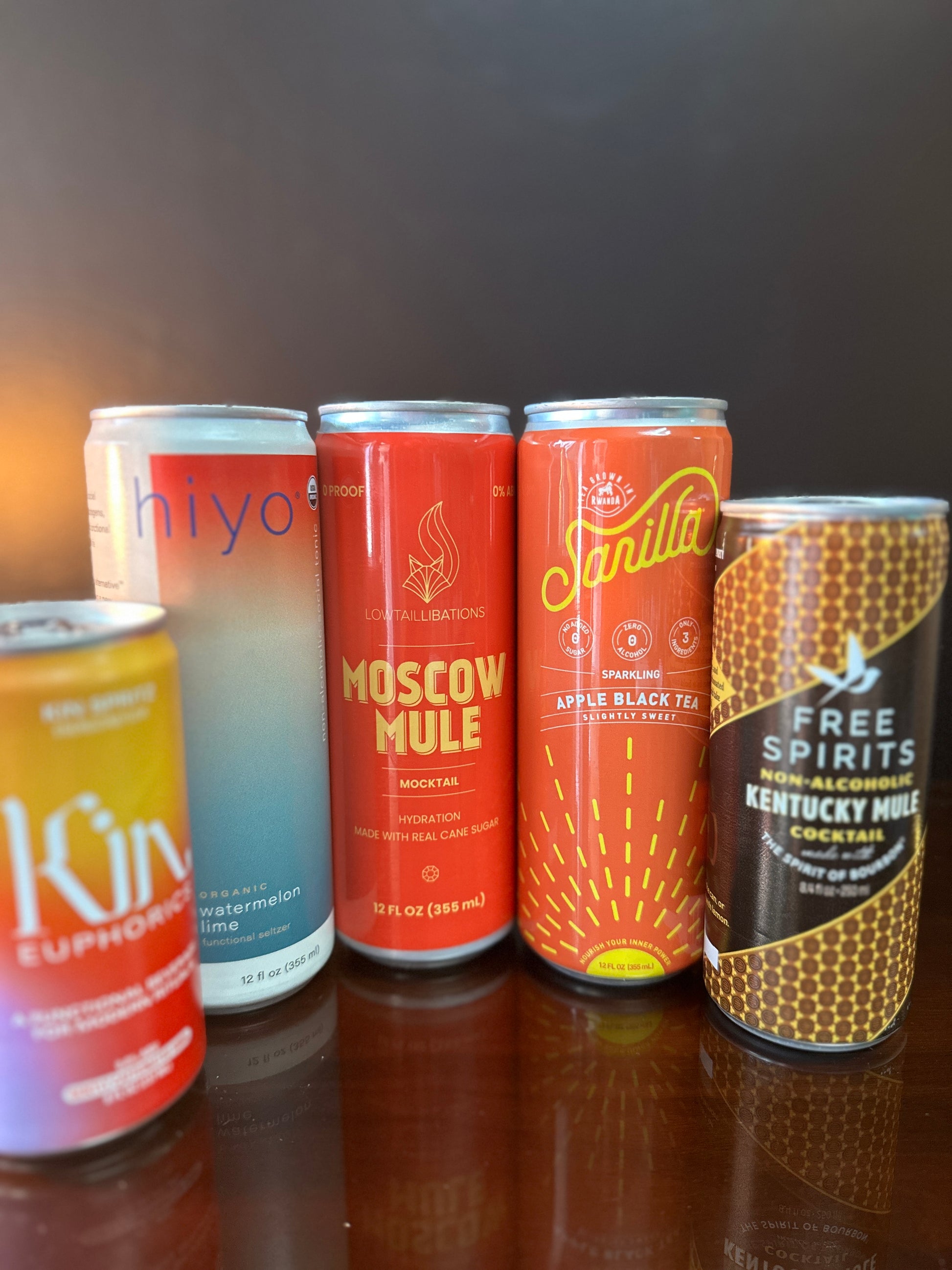 five drinks displayed next to eachother, they are all orange